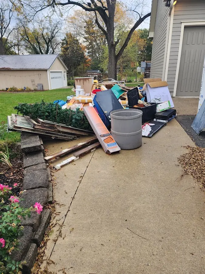 Dumpster being loaded with debris for Roofing Dumpster Rental in West Sacramento